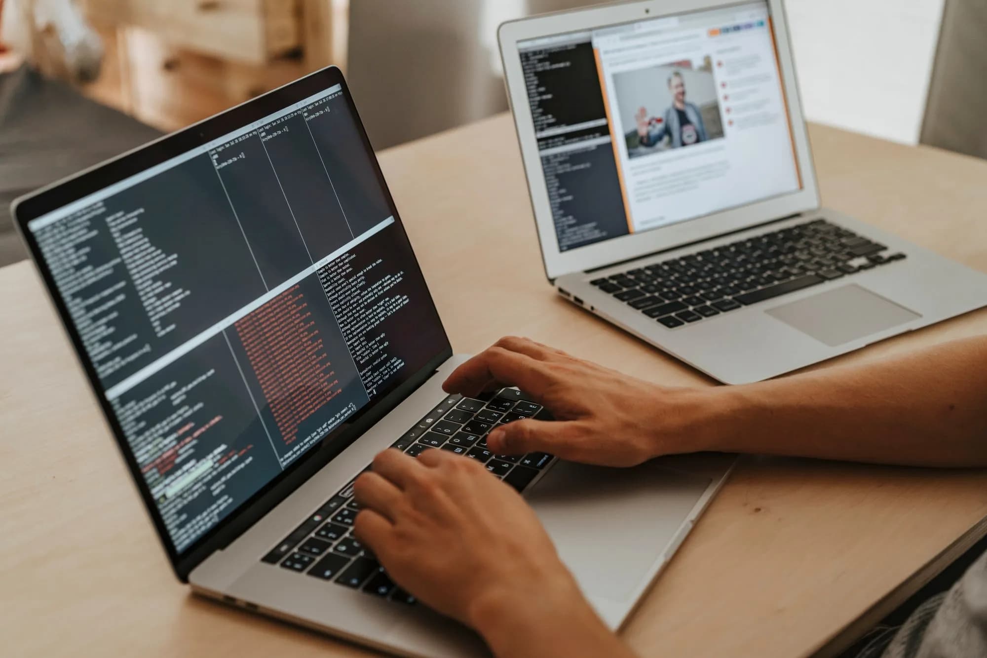 Hands typing code on a laptop